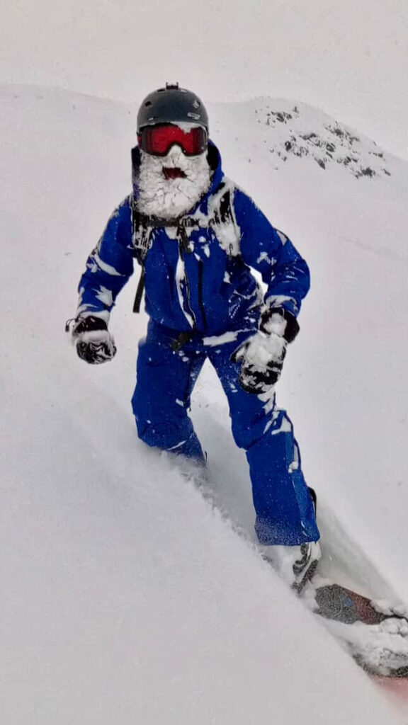 Luke Snow with a beard of snow, in a blue snow suit.