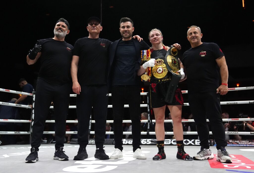 Photo of Ian Gatt (far left) with Lauren Price (2nd right) and her team posing for a photo following Lauren's win over Natasha Jones