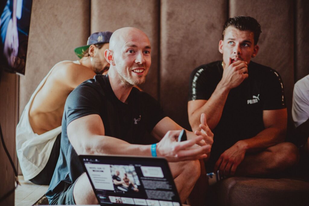 Boxing nutritionist Pete Bell sits speaking to people at a nutrition seminar.