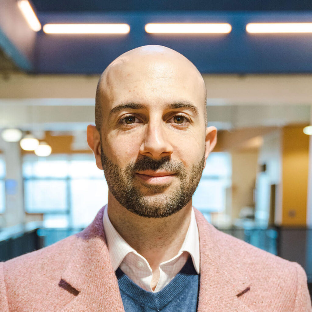 Luca Massaro in a pink suit.