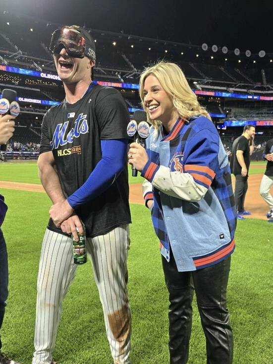 Emily Reppert interviewing a fan on the Mets field