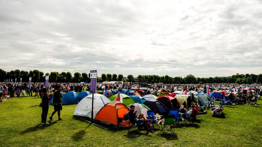 An image of thousands of people and tents forming a queue for the Wimbledon Championships